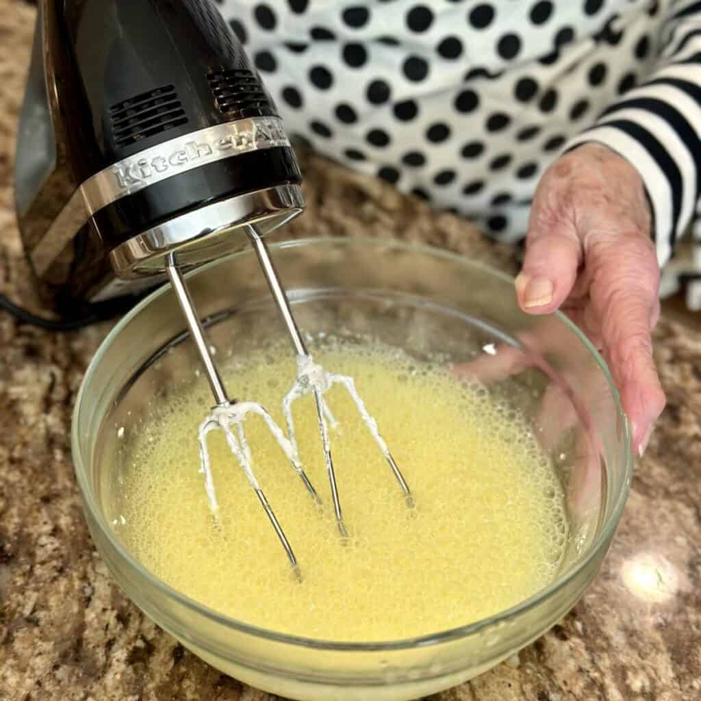 Whipping lemon jello with cream cheese.