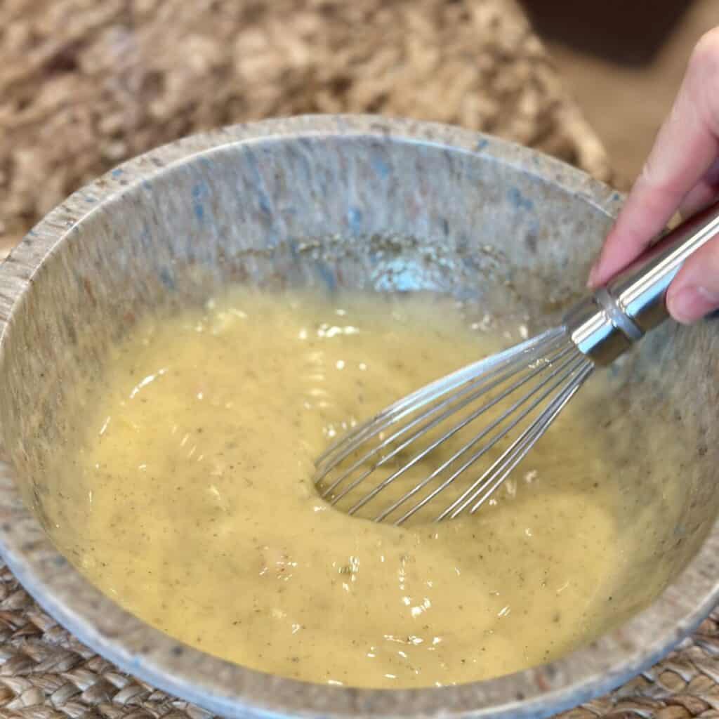 Mixing gravy in a bowl for stuffing.