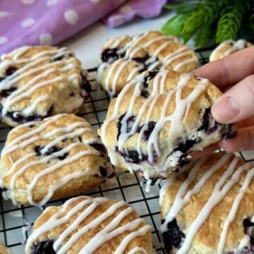 A blueberry biscuit with icing.