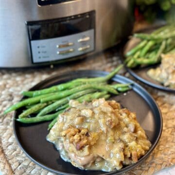 A plate of crockpot chicken and stuffing and beans.