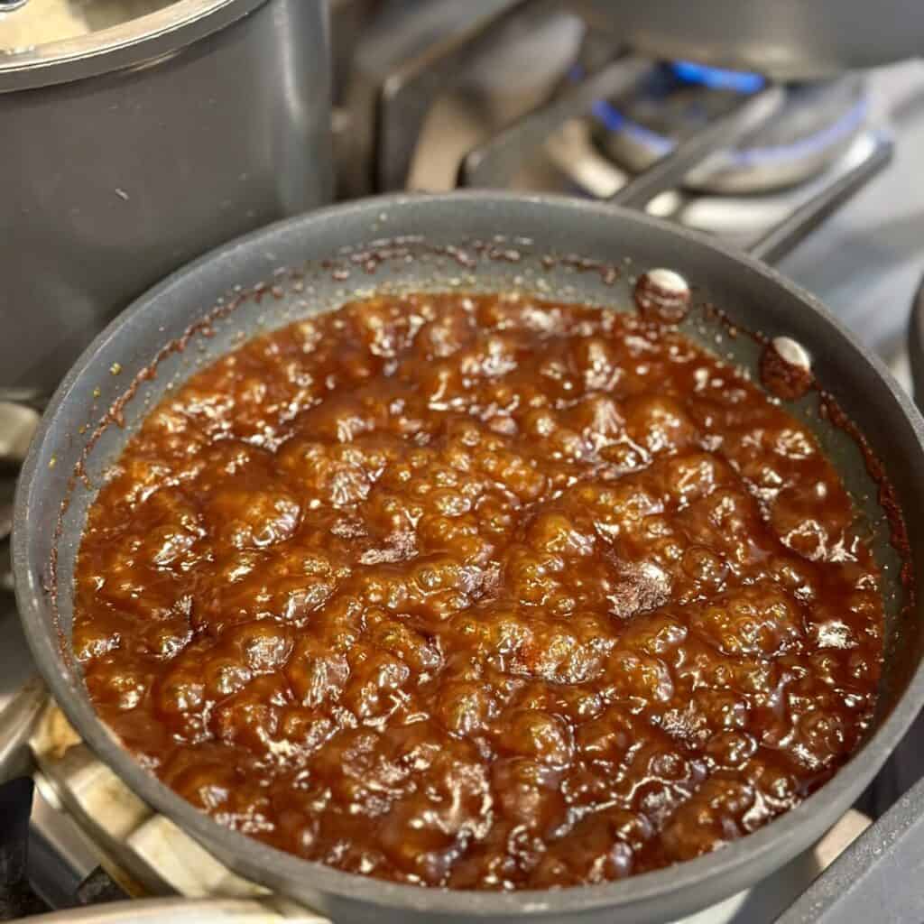 Simmering bbq sauce in a skillet.