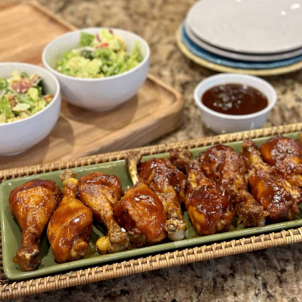 A platter of bbq drumsticks.