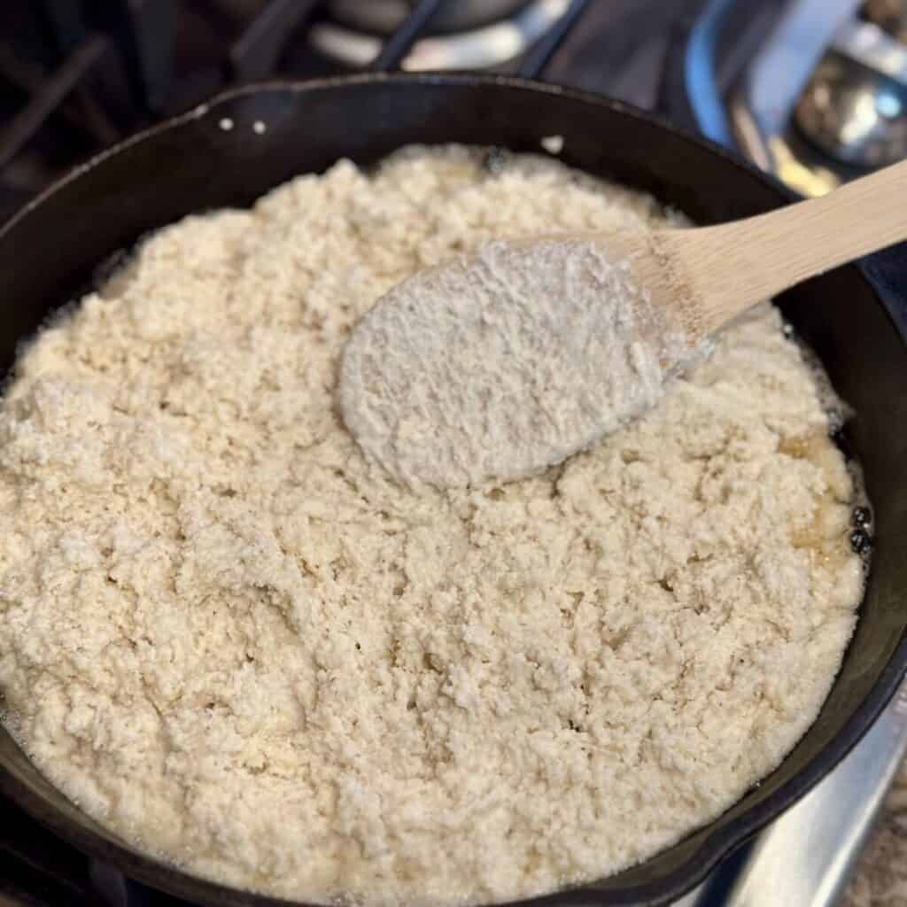 Cornbread batter in a cast iron skillet.