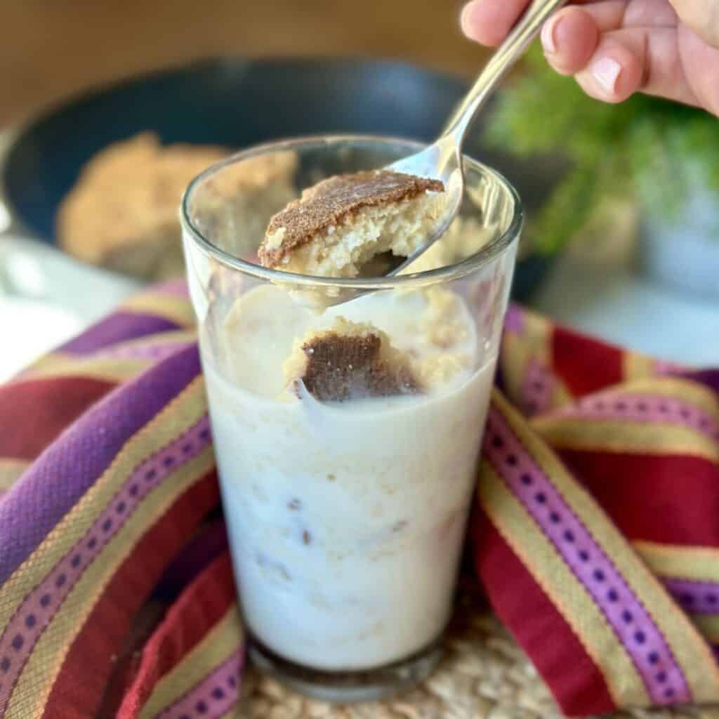 A glass of milk and cornbread.