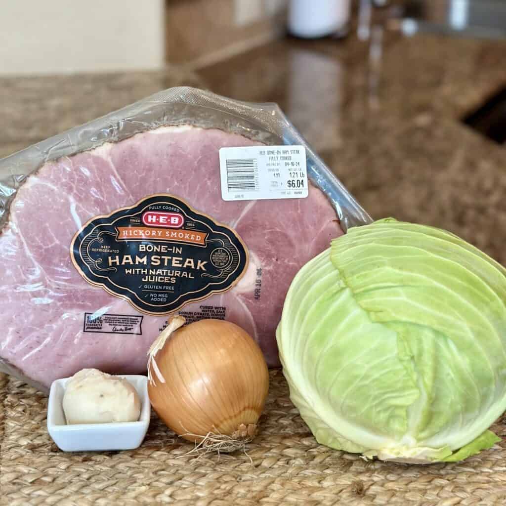 The ingredients to make ham and cabbage.