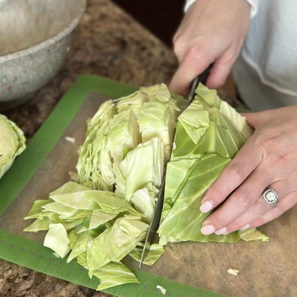 Chopping cabbage on a cutting board.
