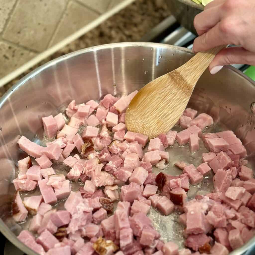 Sautéing ham in a skillet.
