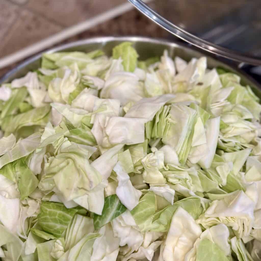 Cooking cabbage in a skillet.