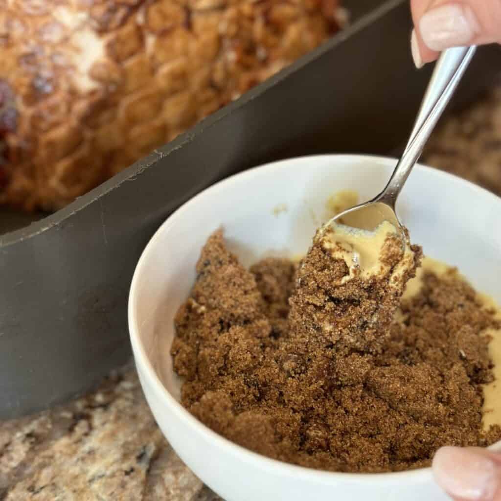 Mixing together brown sugar and mustard.
