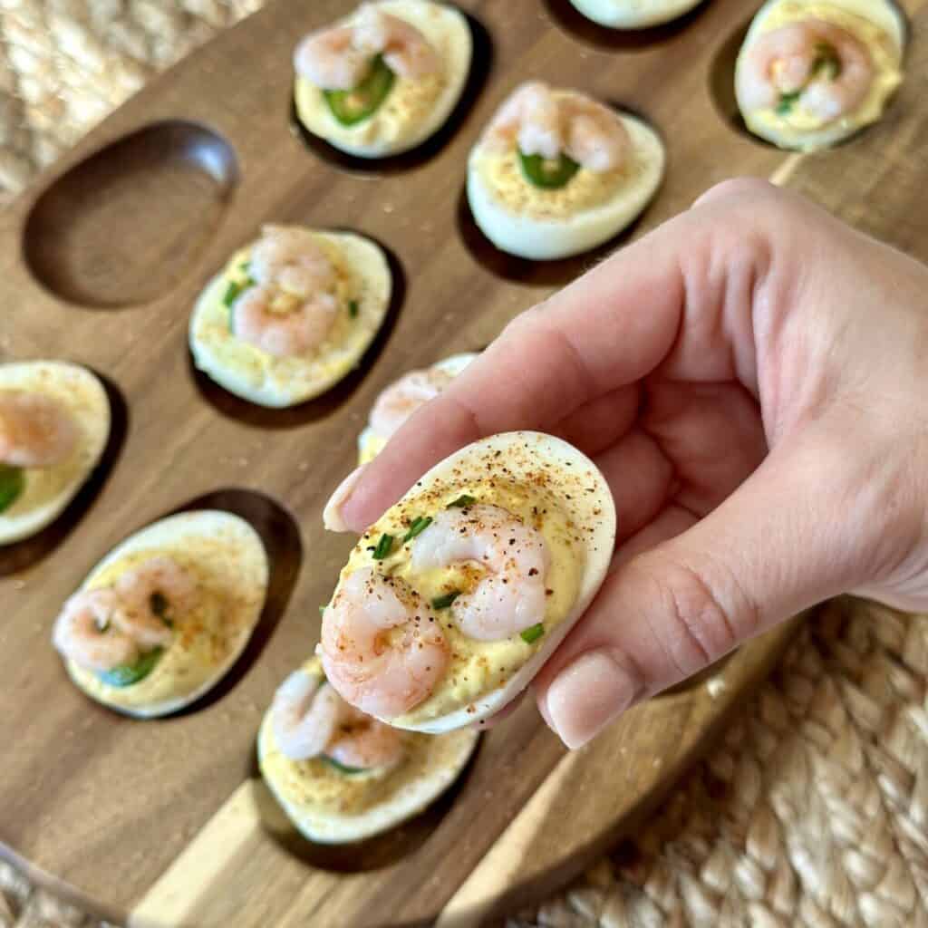 Holding a deviled egg.