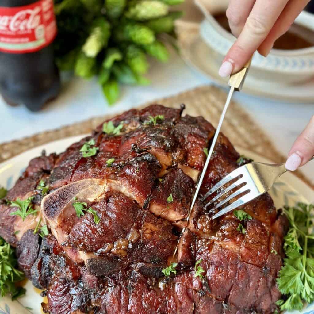 Slicing a glazed ham.