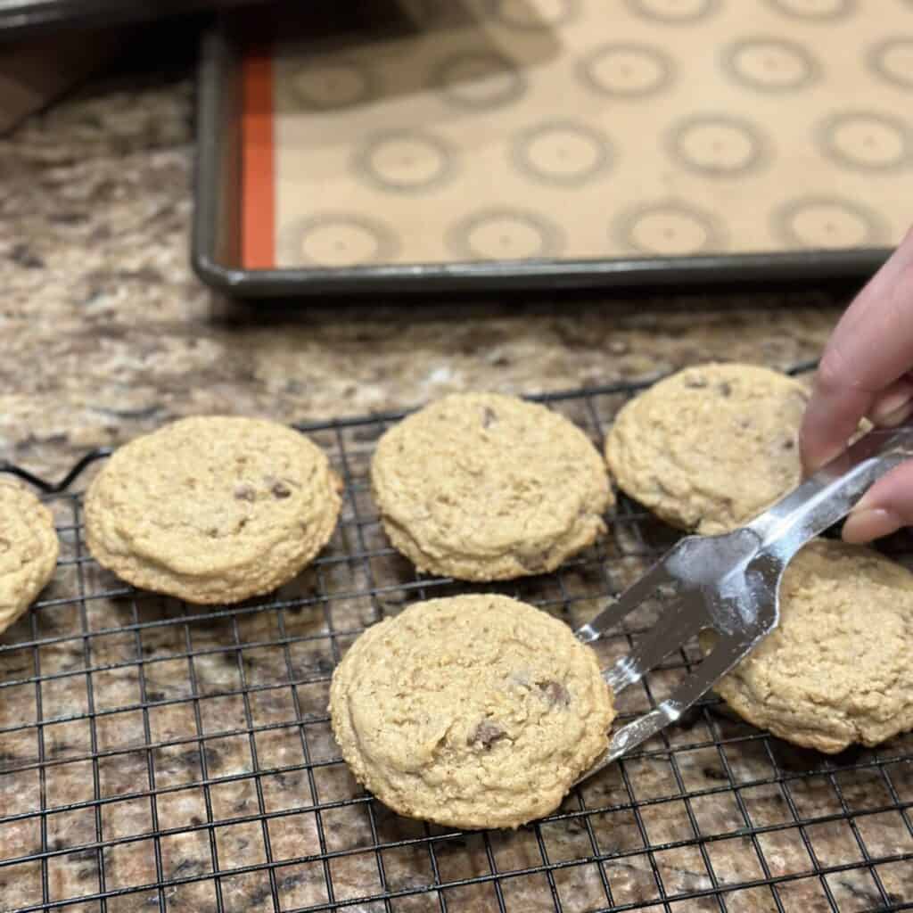 Putting a cookie on a cooling rack.