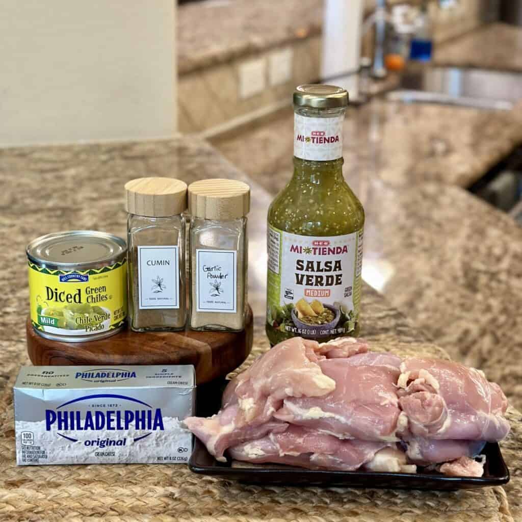 The ingredients to make Crockpot green chili chicken.