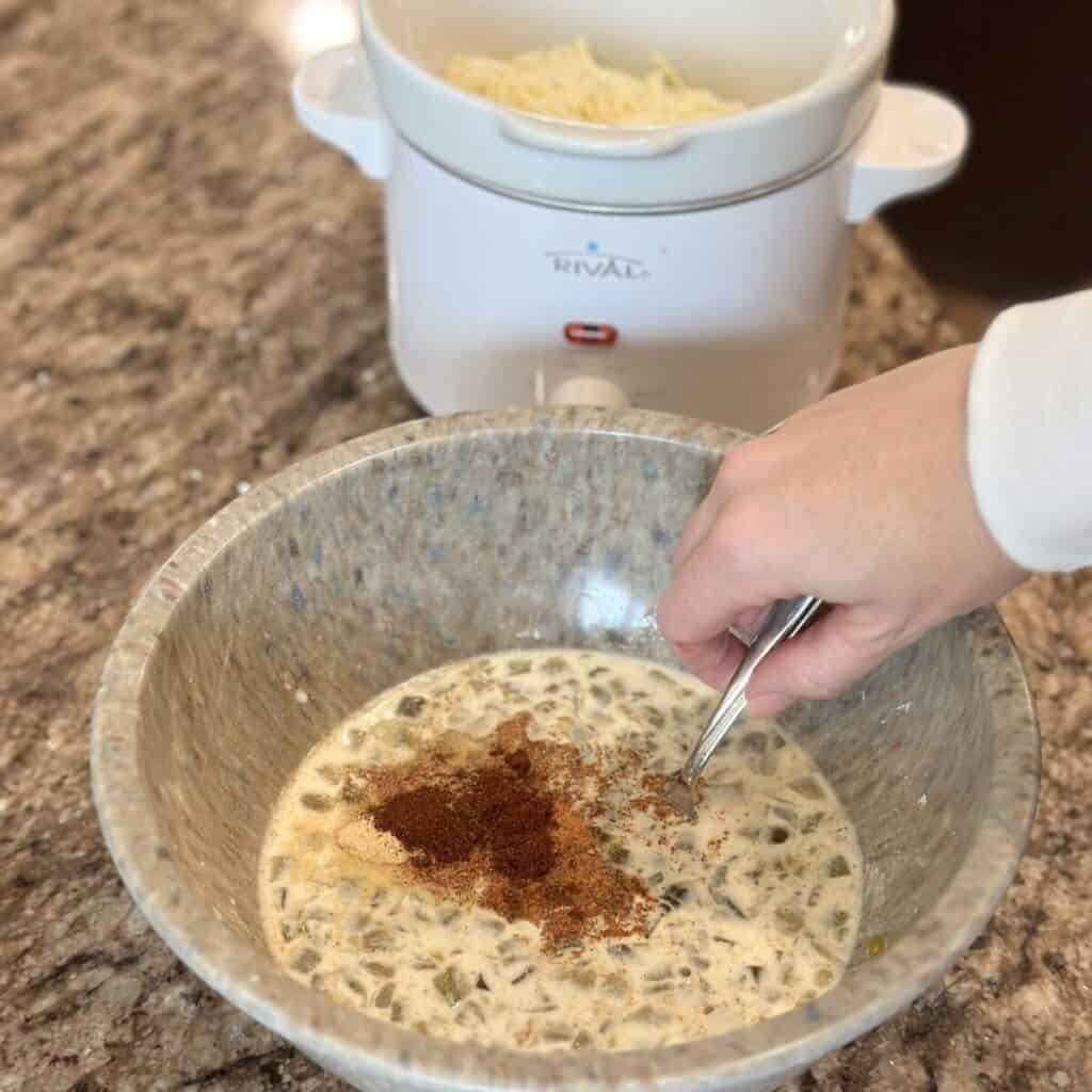 Mixing the liquid together for queso dip in a crockpot.
