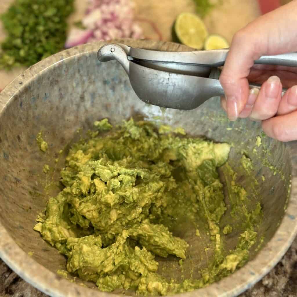 Squeezing lime in guacamole.
