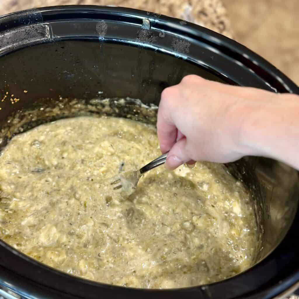 Stirring together the sauce for green chili chicken.