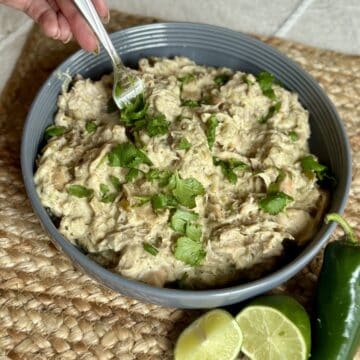 Getting a fork of green chili chicken for tacos.