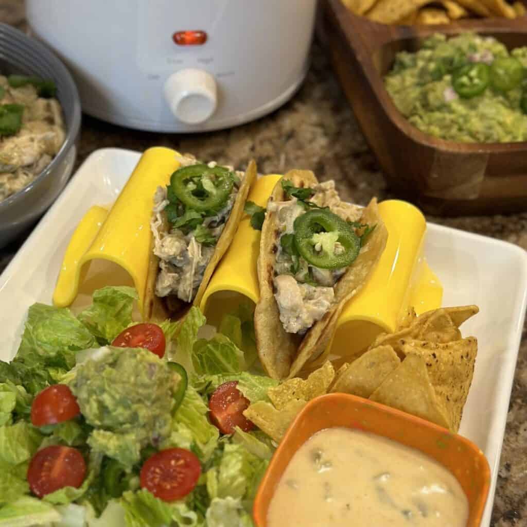 Green chili chicken tacos with vegetables and cheese dip.