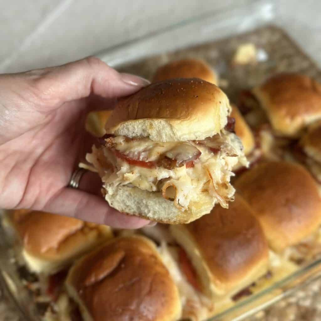 Holding 1 Kentucky hot brown slider in his hand.