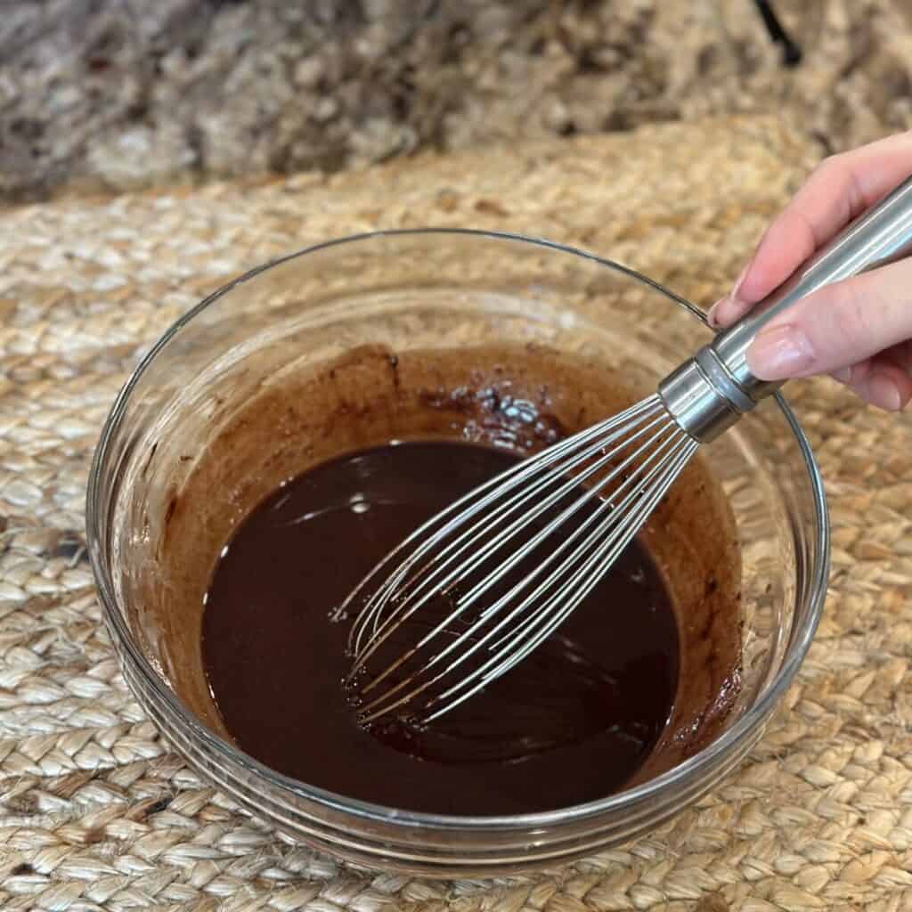 Mixing together chocolate icing.