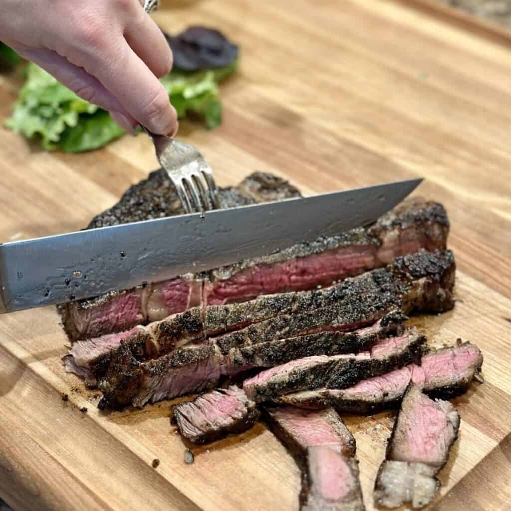 Slicing a ribeye steak.