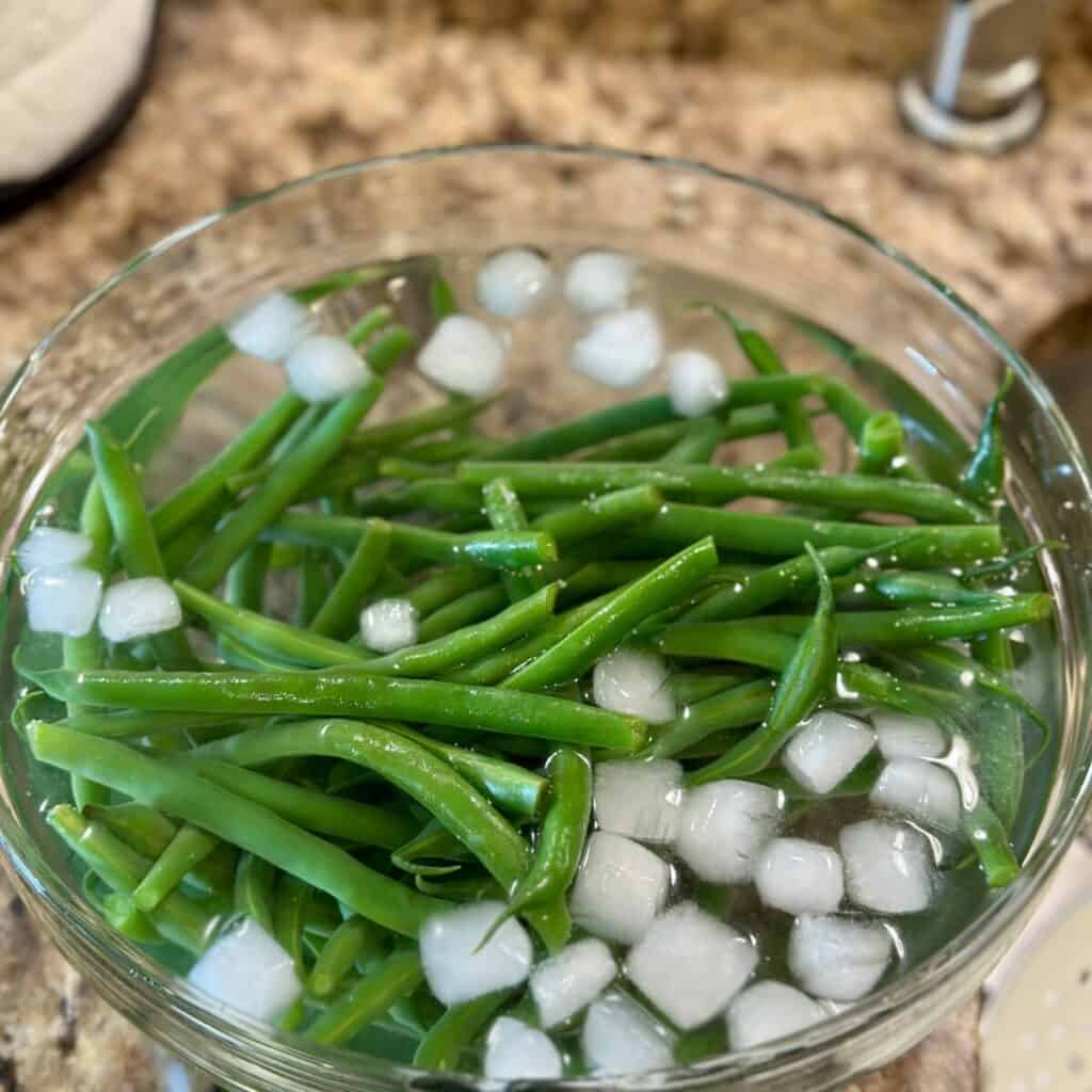 Green beans in an ice bath.