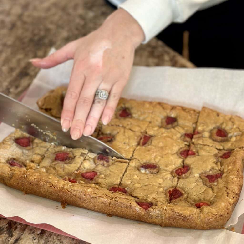 Cutting blondies on a cutting board.