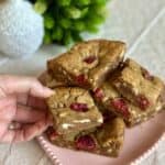 Holding a white chocolate raspberry bar.