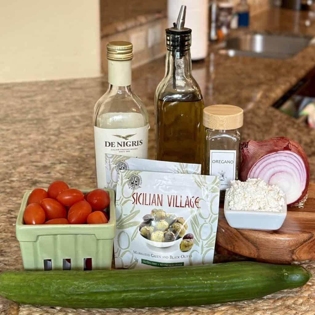 The ingredients to make a Mediterranean tomato and cucumber salad.