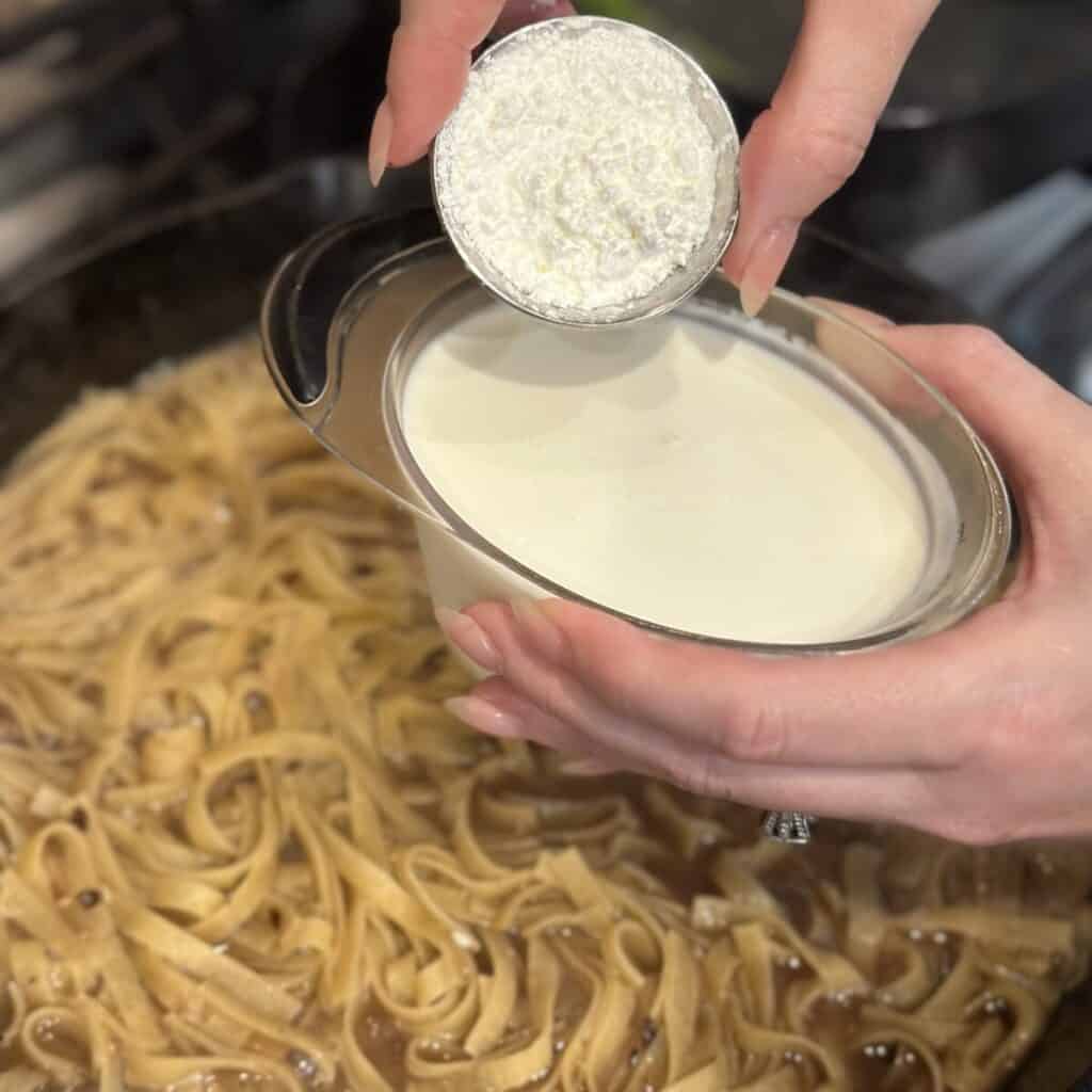 Making a cornstarch slurry in a cup.