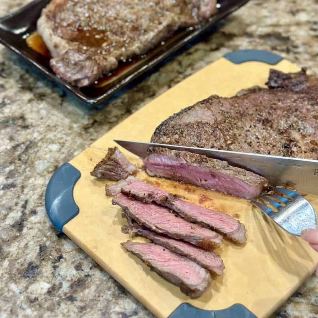 Slicing ribeye steak.