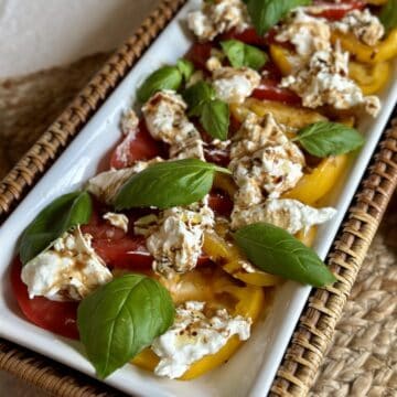 A finished plate of burrata caprese.