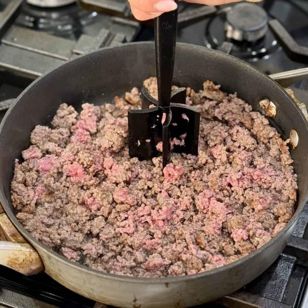 Browning beef in a pan.