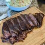 A sliced brisket on a cutting board.