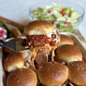 A meatball slider in a baking dish.