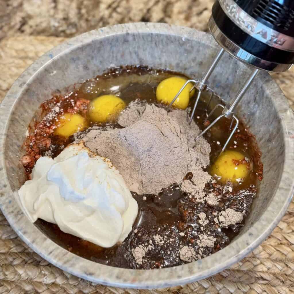 The ingredients for red velvet cake in a bowl.