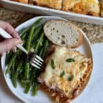 A plate of million dollar spaghetti, green beans and bread.