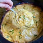 A spoonful of crock pot scalloped Potatoes.