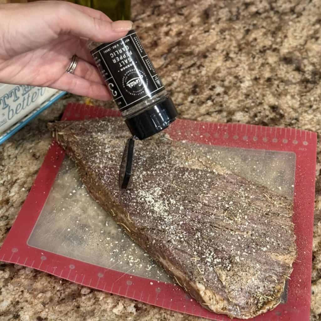 Seasoning a flank steak.