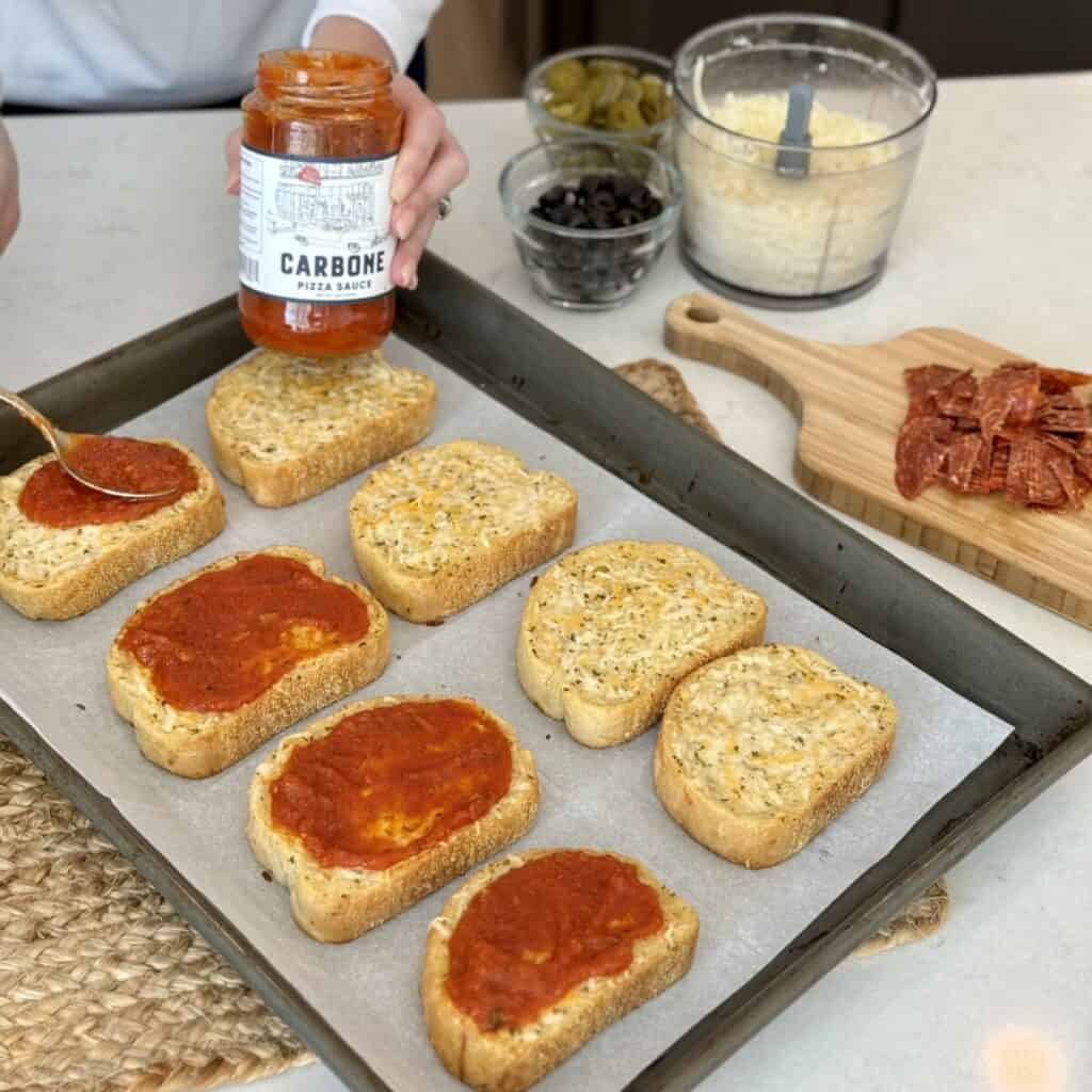 Adding sauce to Texas toast.