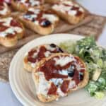 A plate of Texas toast pizza and a salad.