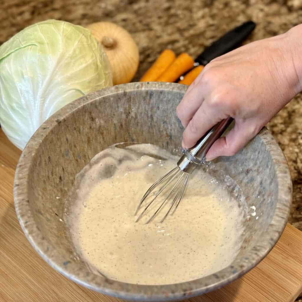 Mixing the ingredients in a bowl for the dressing to make KFC coleslaw.