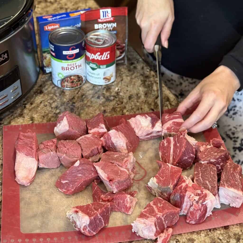 Cutting a roast in cubes.