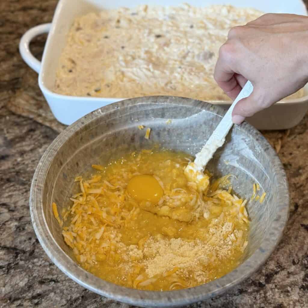 Mixing together the cornbread layer for chicken cornbread casserole.