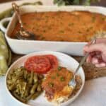 A plate of chicken cornbread casserole, green beans and tomatoes.