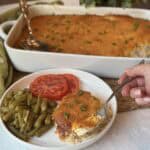A plate of chicken cornbread casserole, green beans and tomatoes.