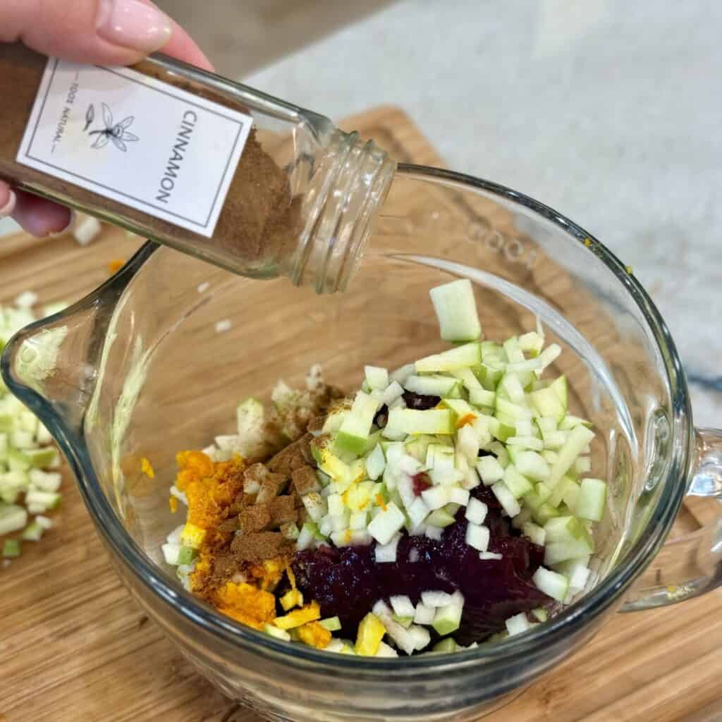 Mixing together the ingredients in a bowl for homemade whole berry cranberry sauce.