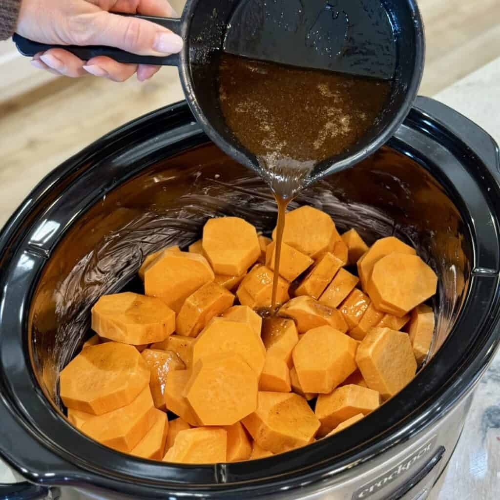Adding the ingredients for crockpot sweet potato casserole in a crockpot.