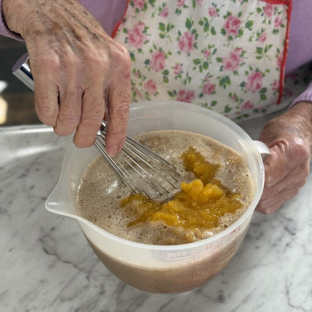 Whisking together the filling for cushaw pie.
