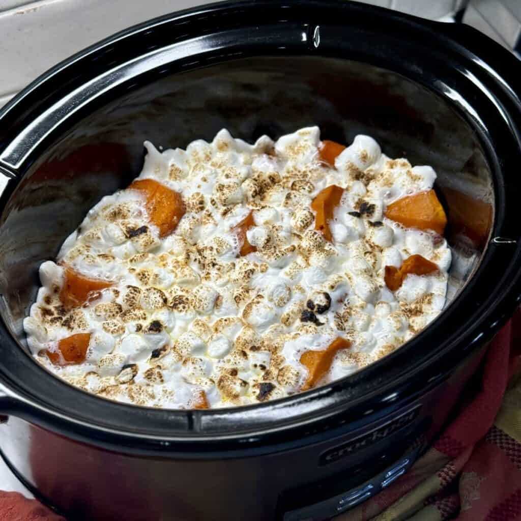 A crockpot full of crockpot sweet potato casserole.
